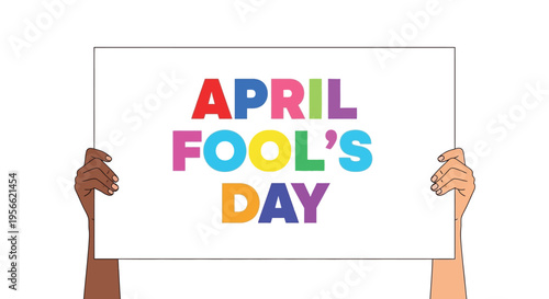 Hands holding a colorful sign reading april fool s day