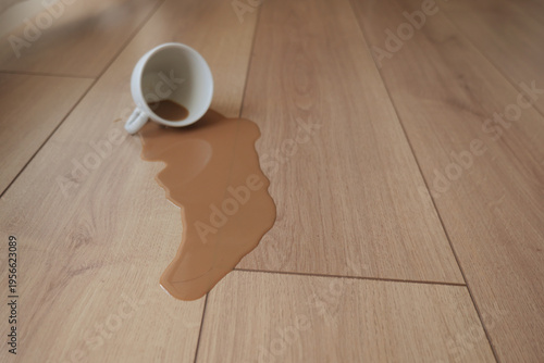 Bilde på lerret Coffee spills on wooden floor during a busy morning time