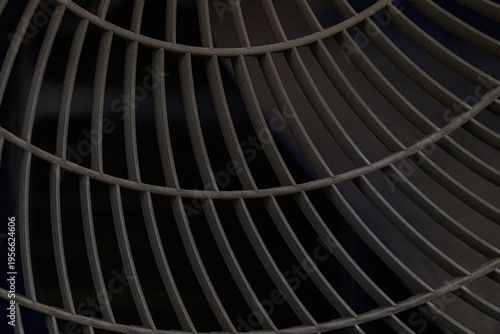 Abstract dark metal fan grid pattern with concentric curved bars