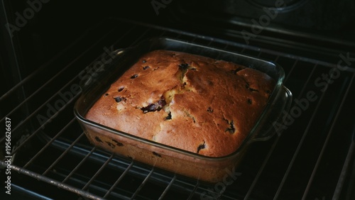 Homemade berry pie in the oven in a glass dish. Concept of home baking, comfort food, and traditional dessert preparation