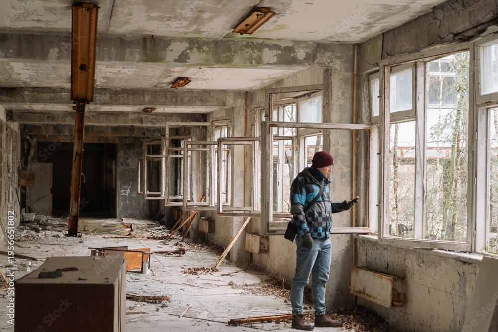 Fototapeta premium Man exploring abandoned building in Chernobyl