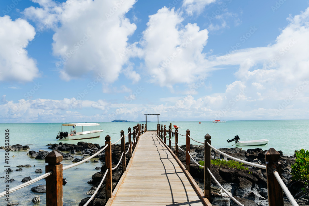 Fototapeta premium Tropical beach jetty in Mauritius resort with turquoise sea and sky.