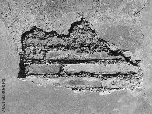 Detail of the plaster on an old terracotta brick wall.