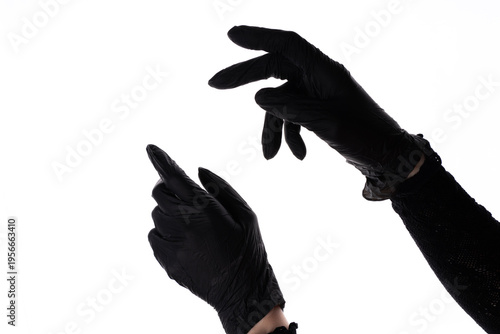Female hand wearing black protective glove with fingers spread, isolated on white background, studio closeup of hygiene and safety equipment.
