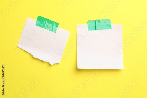 Reminder. Sticky notes on yellow background, top view