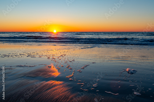 Seaside Sunrise with Cloud Reflections on Beach