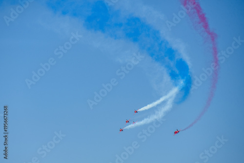 A group of aerobatic jet aircraft flying in perfect formation du