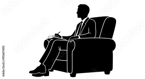Businessman sitting in chair working on laptop focused on screen professional attire