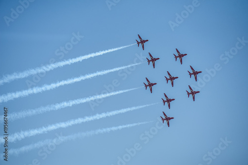 A group of aerobatic jet aircraft flying in perfect formation du