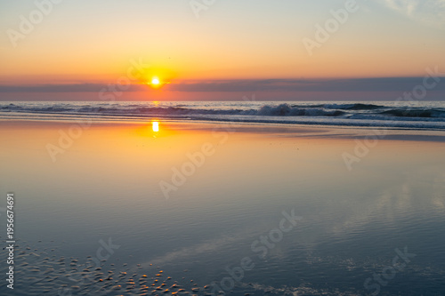Beach Sunrise with smooth sand reflections