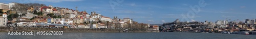 Panoramic view of Porto riverside cityscape with colorful houses and historic architecture by Douro river