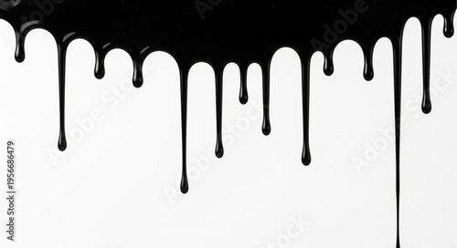 Black paint drips on white.