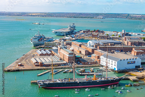 Фотография HMS Warrior battle ship and modern aircraft carriers at port of