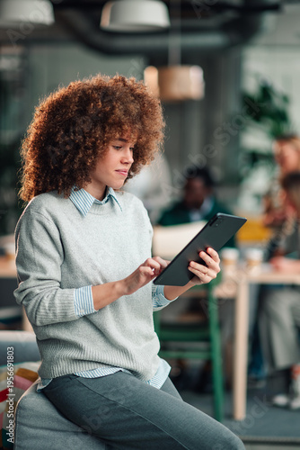 Young woman using tablet in modern office