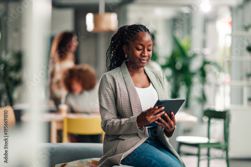 Black businesswoman using digital tablet in modern office