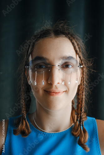  smiling young woman with braids wearing unique cloud shaped glasses with dangling crystal rain chains. Hidden depression