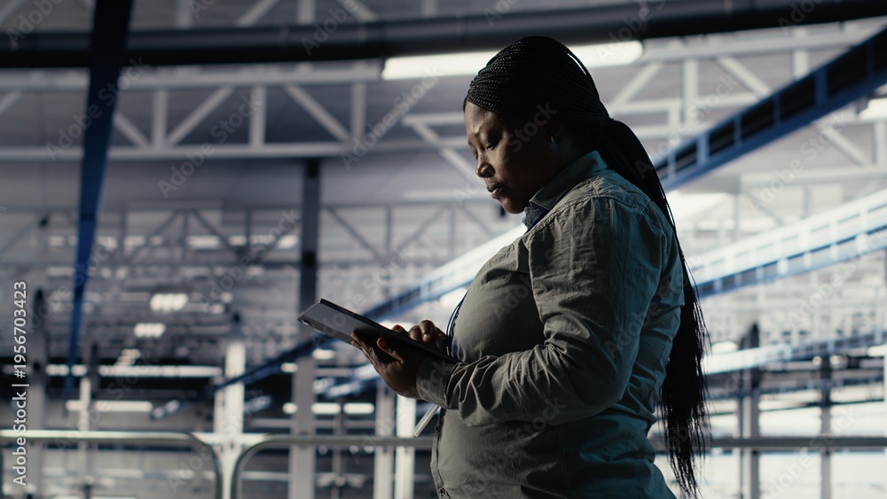 Fototapeta premium Data center software developers deploy machine learning software on infrastructure racks. Server room IT specialists train AI systems with datasets using tablet to support applications, camera B