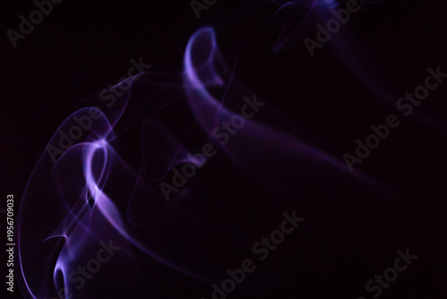 Bilde på lerret Soft purple smoke swirls gently against a dark background creating an ethereal a