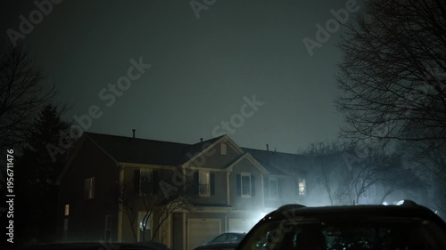 Night shoot of suburb street during the storm. Flashing lightening of thunderstorm light up the sky . 