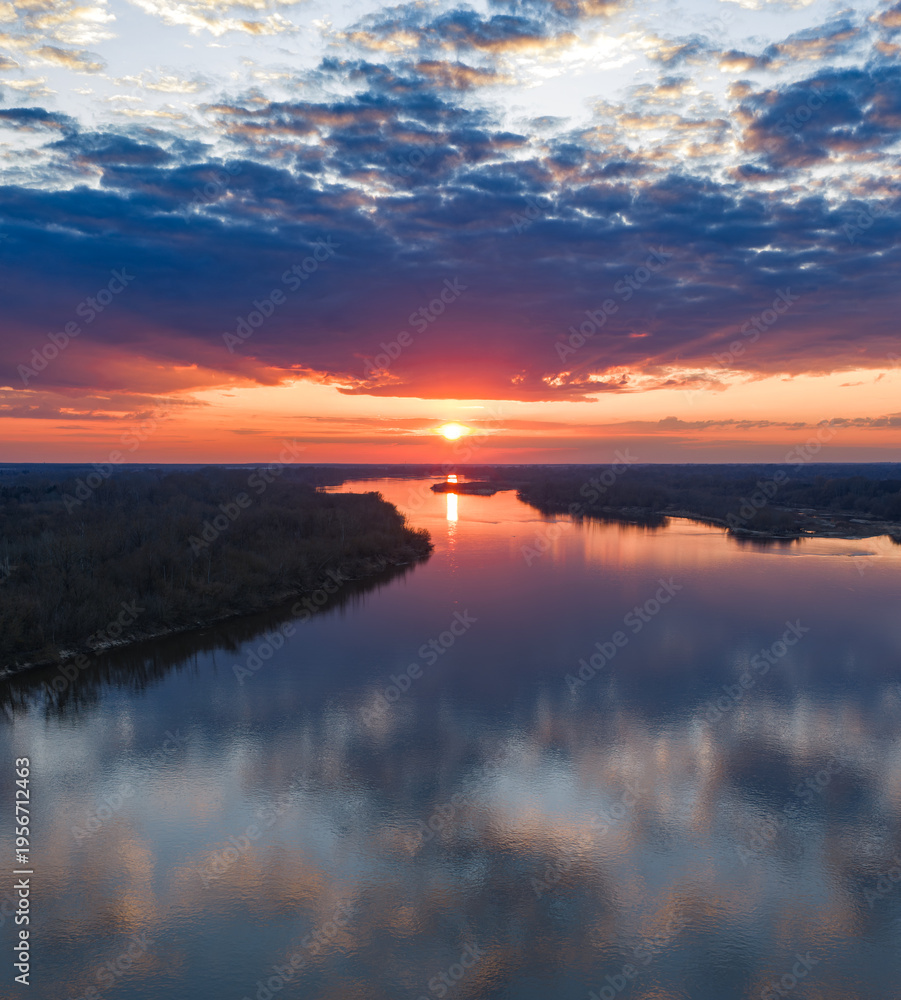 Obraz premium Vistula River near Warsaw at sunset with mirrored sky reflections