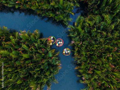Canvas Print Aerial view of colorful coconut bamboo boats in lush palm forest, hoi an, vietna