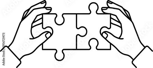 Two hands holding matching jigsaw puzzle pieces together for partnership and teamwork concept representing successful collaboration in professional environment