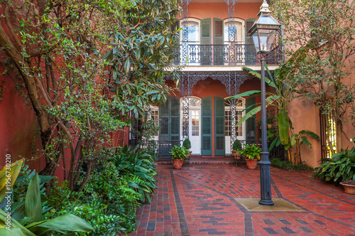 Cozy front yard of the typical French Quarter house adorned with green plants, New Orleans, USA