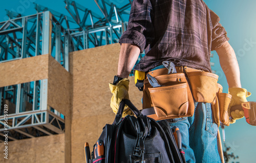 Worker Stands With Tools at Construction Site