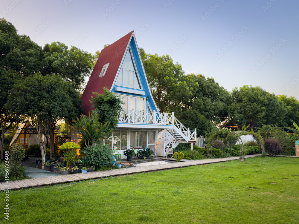 Fototapeta premium Charming A-Frame House Nestled in Lush Greenery with Serene Atmosphere