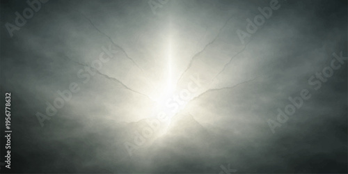 Golden sun light rays pierce through dark stormy clouds over a gray misty sea creating a dramatic nature texture in the sky