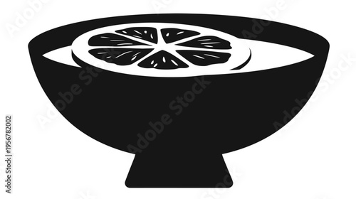 A simple, monochrome illustration of a bowl filled with liquid and a slice of citrus fruit