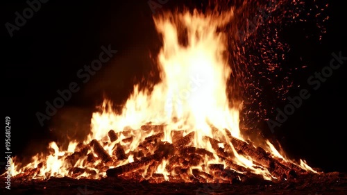 Wallpaper Mural A vibrant bonfire glows brightly against a dark backdrop, with sparks rising Torontodigital.ca