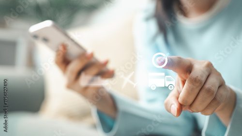 Woman using smartphone to choose shipping method and delivery options with virtual logistics icons showing courier service, transportation and parcel tracking.