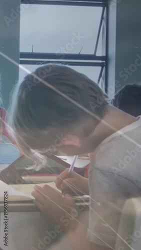 Vertical video: Pupil prompted to finish work leaning writing pen overlay connecting notes in class