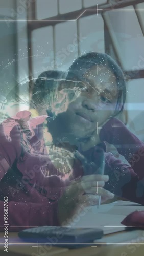 Vertical video: Pupil tapping pen while writing and studying causing holo globe drifting over desk