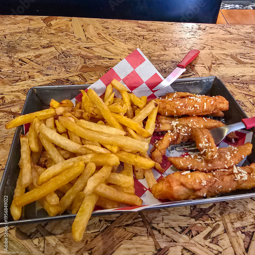 View of typical Peruvian food with Pollo a la braza (rotisserie chicken) with french fries and cheese
