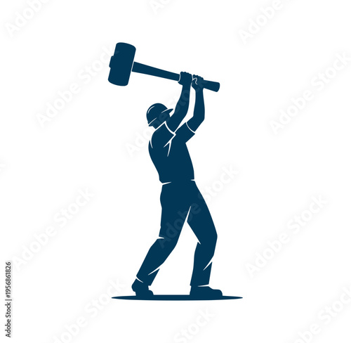 Man wearing hard hat swinging large sledgehammer overhead in action