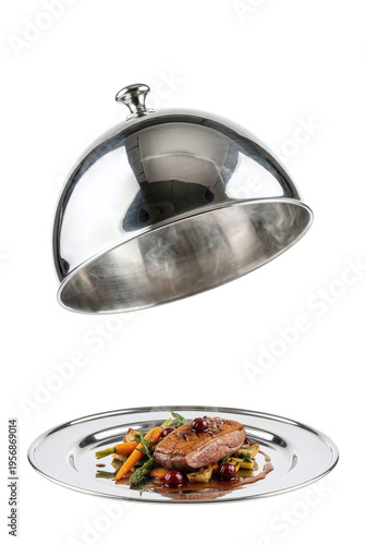 Gourmet duck breast dish served under a silver cloche