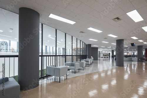 Wide lobby lounge with columns and soft seating in modern institution
