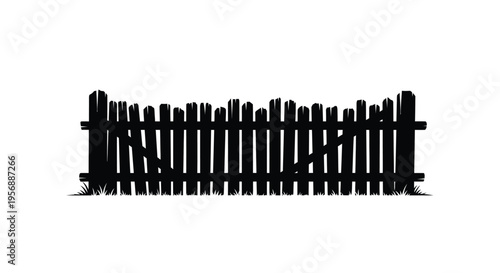 A rustic wooden fence stands against a bright background silhouette