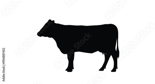 A black silhouette of a cow standing in a field silhouette