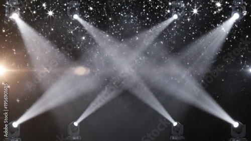 Stage spotlights illuminate a dark background with sparkling lights