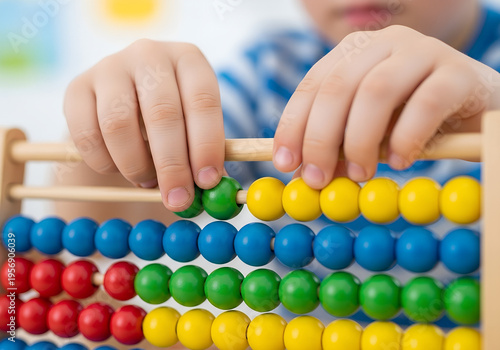 Young child using colorful abacus to learn counting skills  