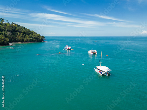 Aerial view of boats surrounded by turquoise sea on a paradisiacal morning in the Puntarenas Province of Costa Rica