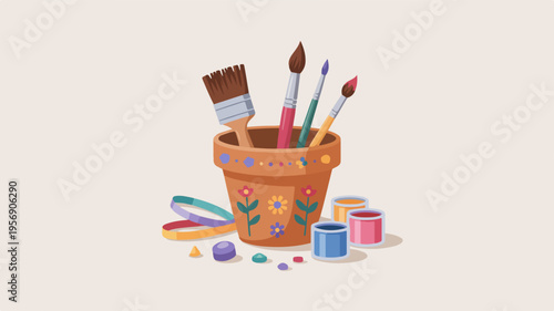 Colorful paintbrushes and art supplies in a terracotta pot on a plain background for creative projects