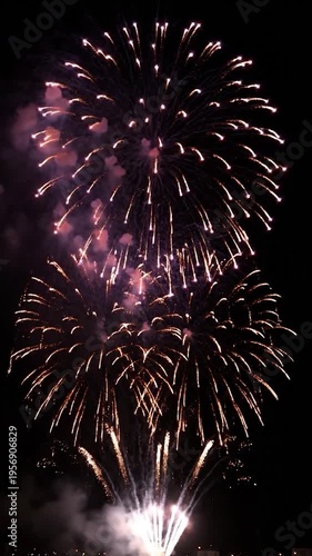 Colorful pyrotechnic displays illuminate the night sky with bursts of light