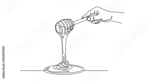 Hand holding honey dipper with dripping honey