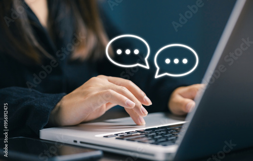 Business communication concept with woman typing on laptop and chat bubbles interface, representing online messaging, customer support, digital conversation and modern technology interaction.