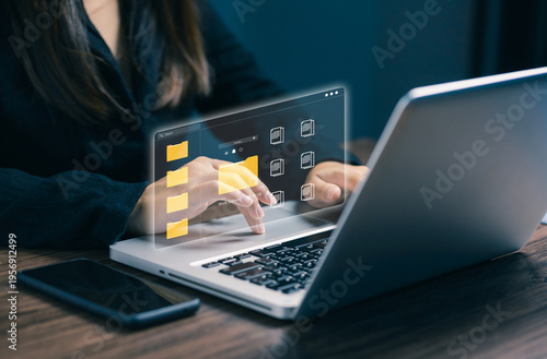 Digital file management system concept with woman using laptop and virtual folders interface, representing cloud storage, data organization, document management, business workflow.