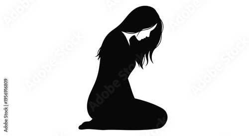 Woman kneeling in despair head in hands a dark silhouette